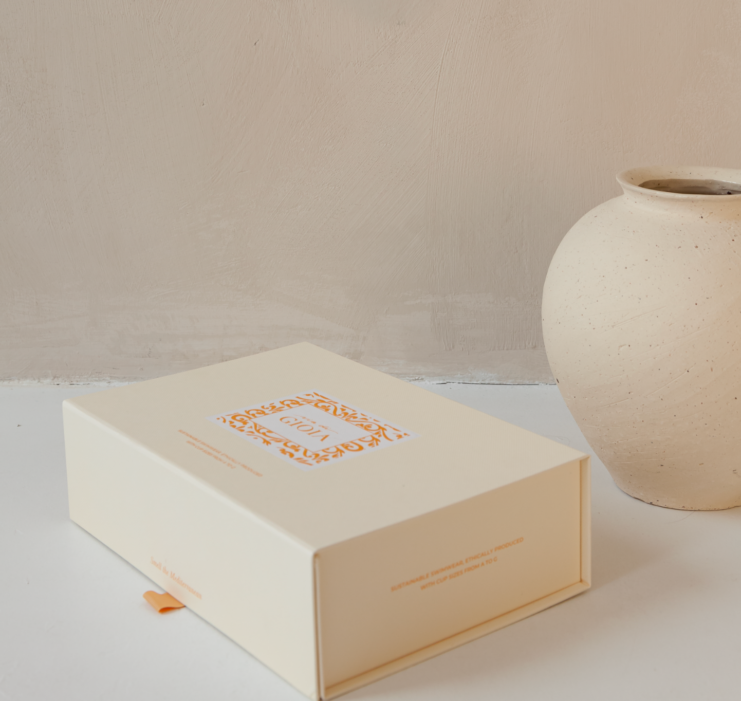 Plastic-free and reusable box for bikini packaging with beige background