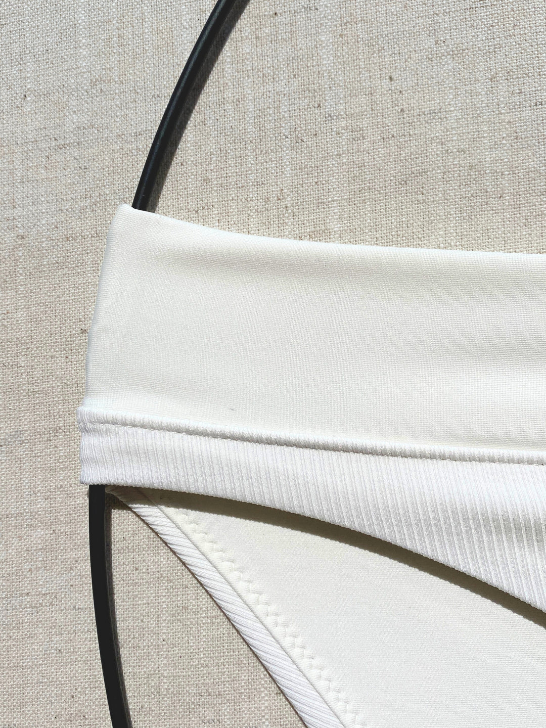 Bikini-bottom-classic-ivory-white-with-rib-fabric-and-embroidery-waistband-close-up